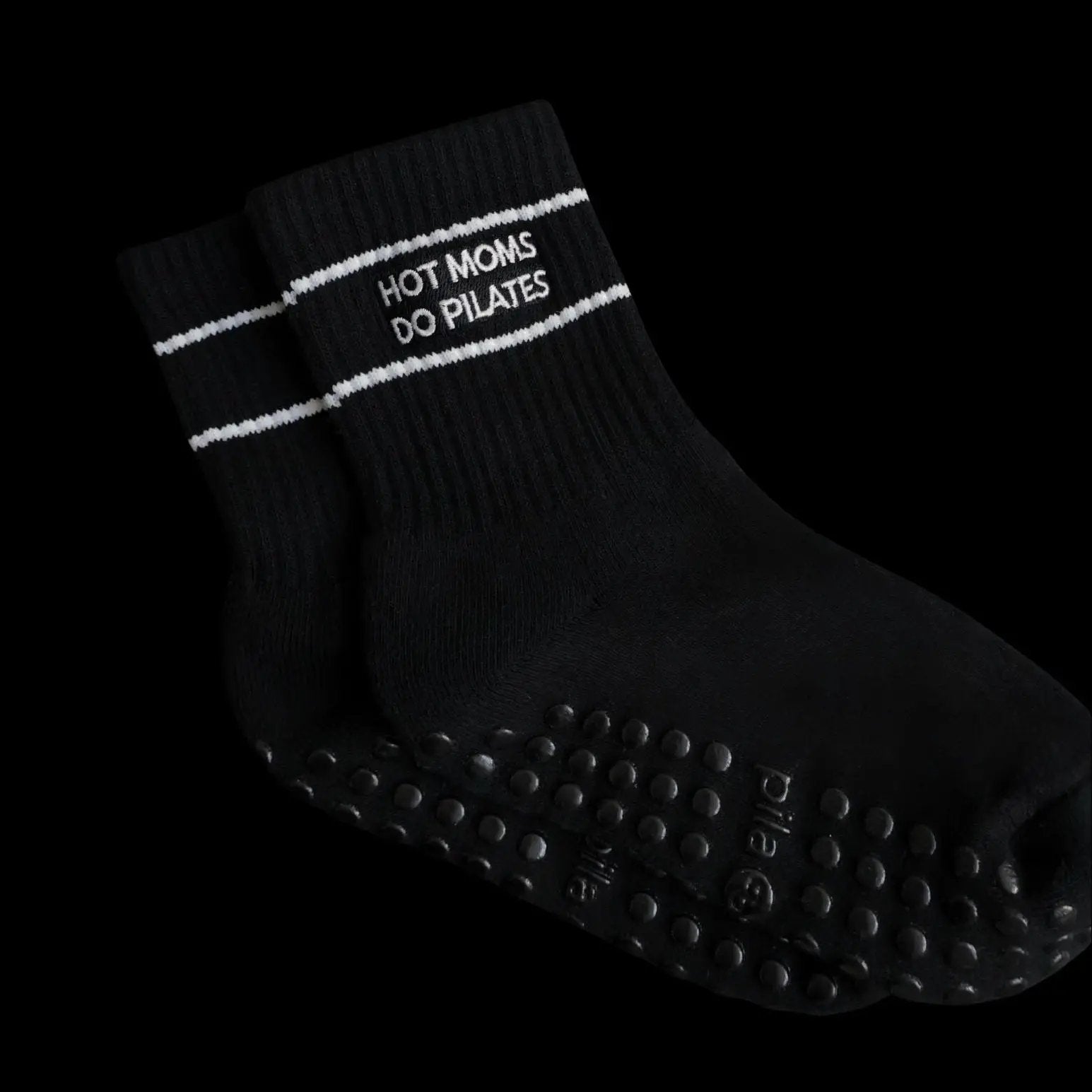 Black sock with 'Hot Moms Do Pilates'