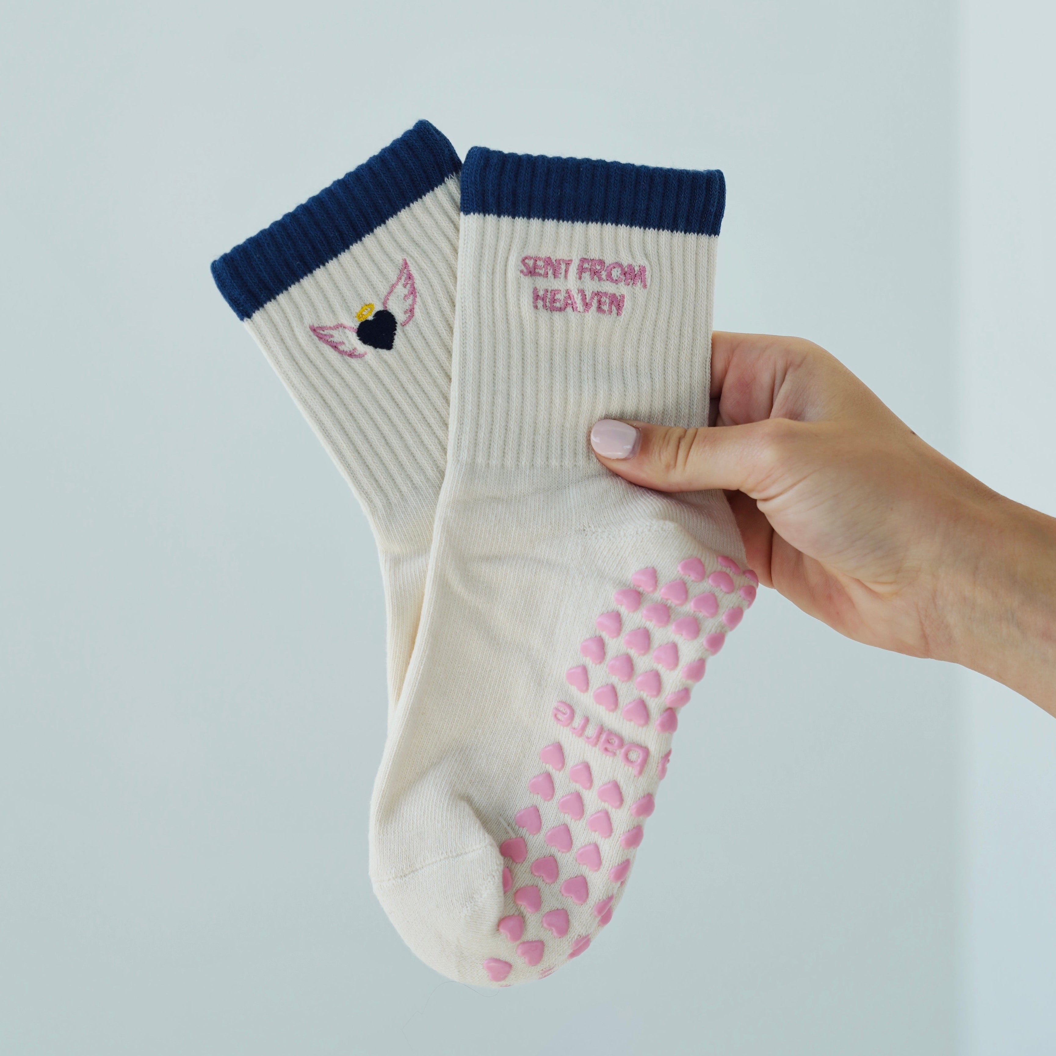 sent from heaven grip socks from pilabarre. cream grip socks with navy details. pilates socks with angel wings and pink embroidery