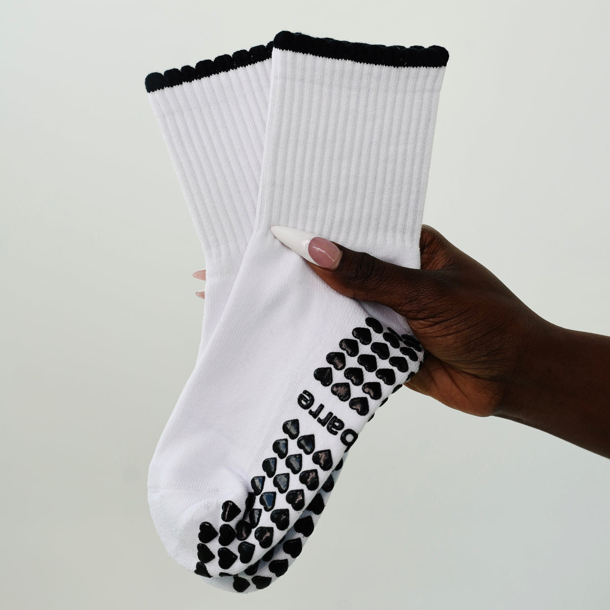 white and black grip socks with ruffles