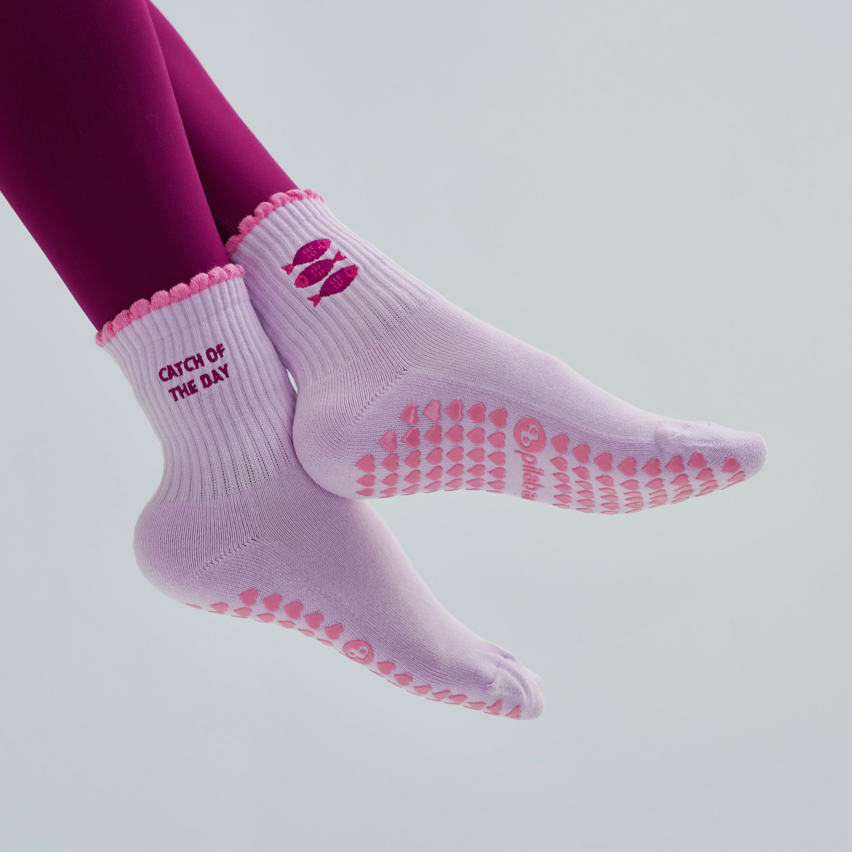 Catch of the day pilates socks with sardines. Lavender and pink grip socks with little fish