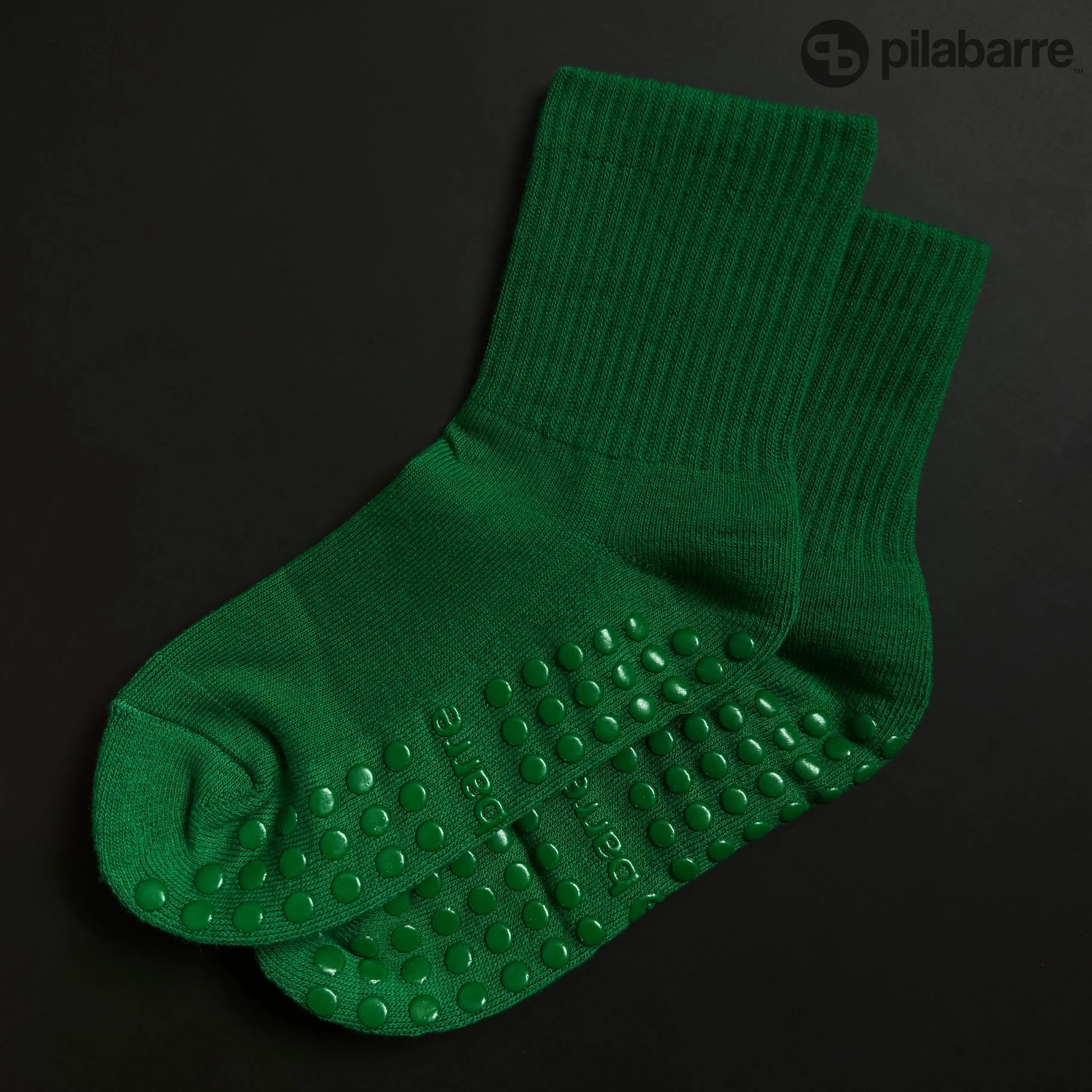 Green Grip socks on a black background