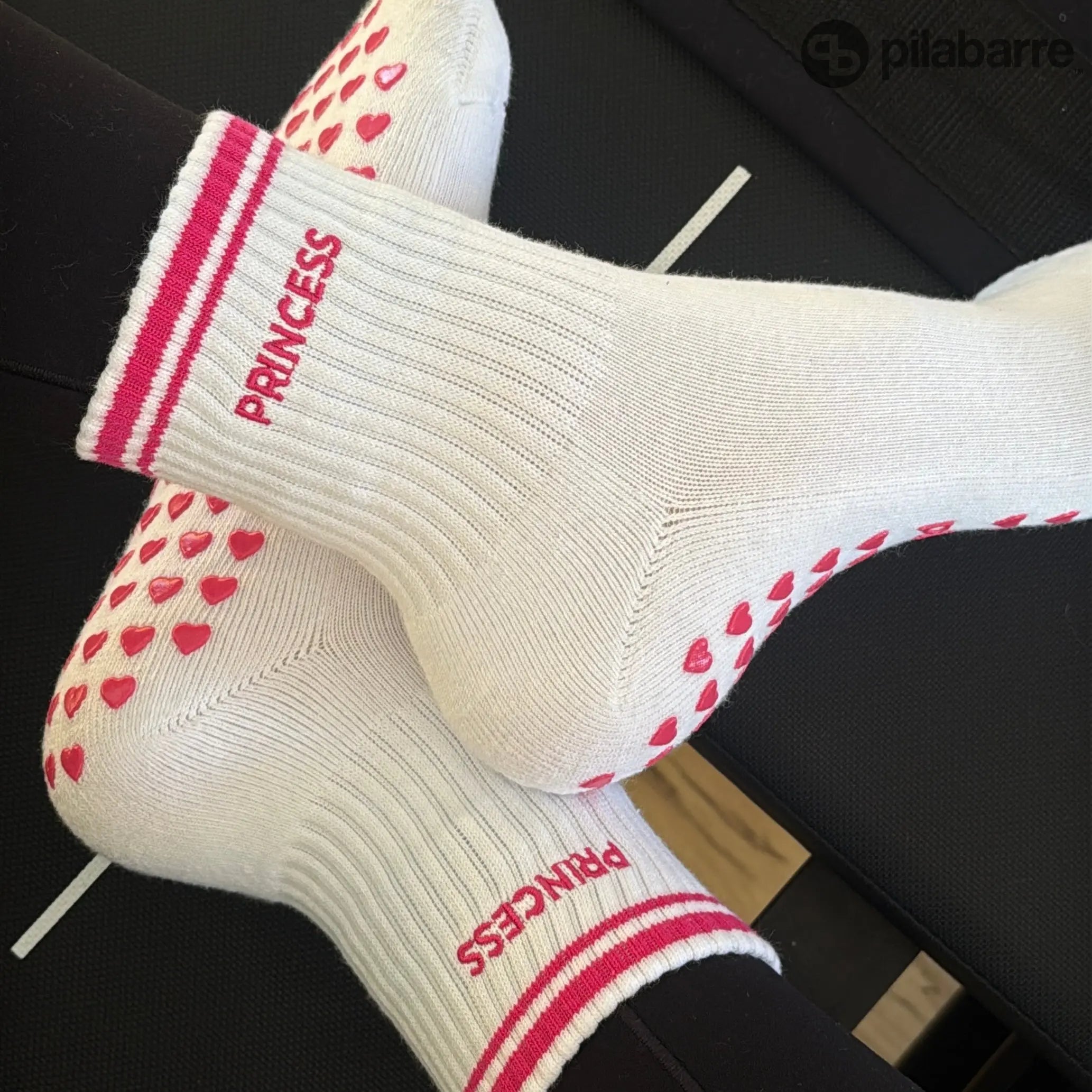 Pilates princess socks on reformer with hot pink