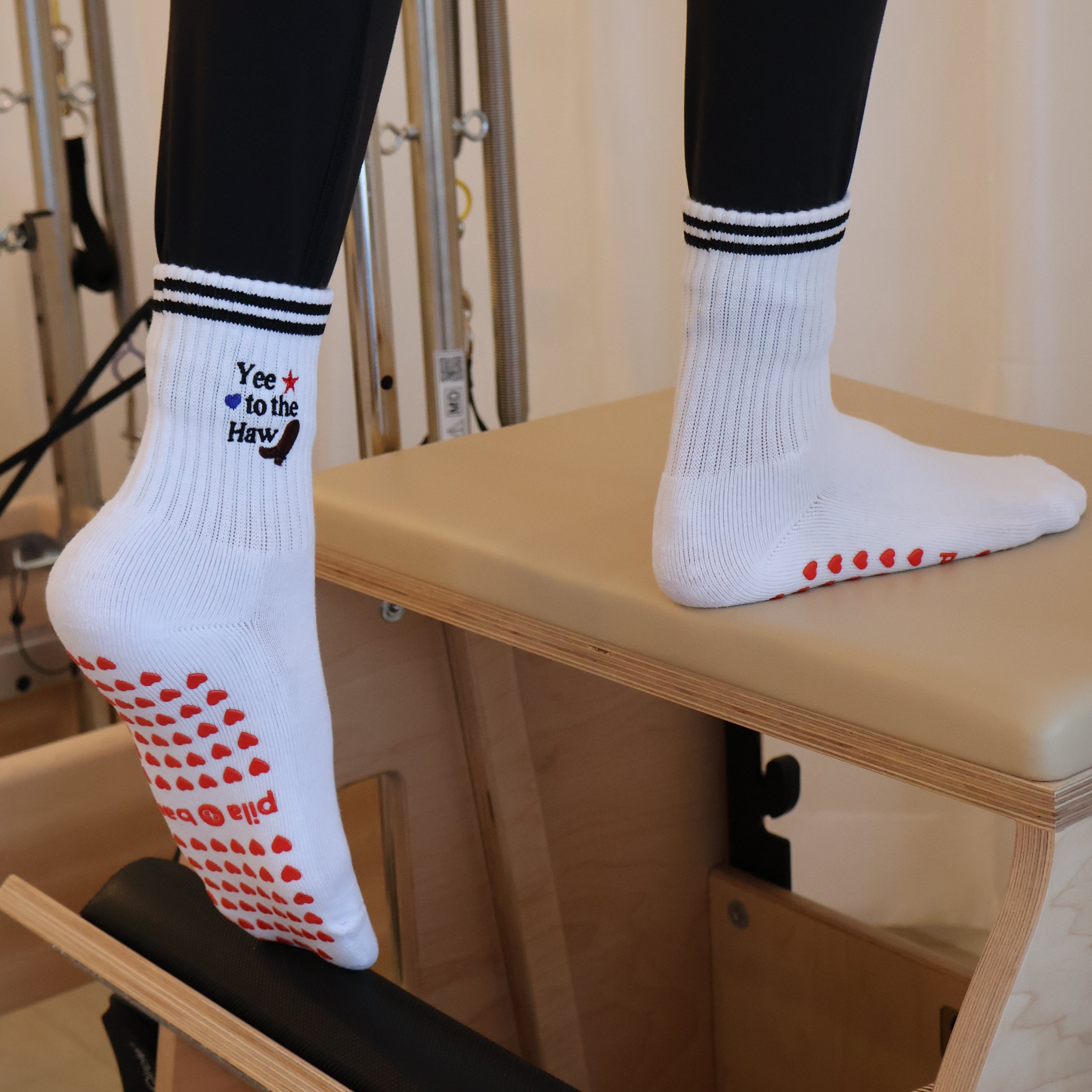 Yee to the haw grip socks on a pilates chair - western pilates socks