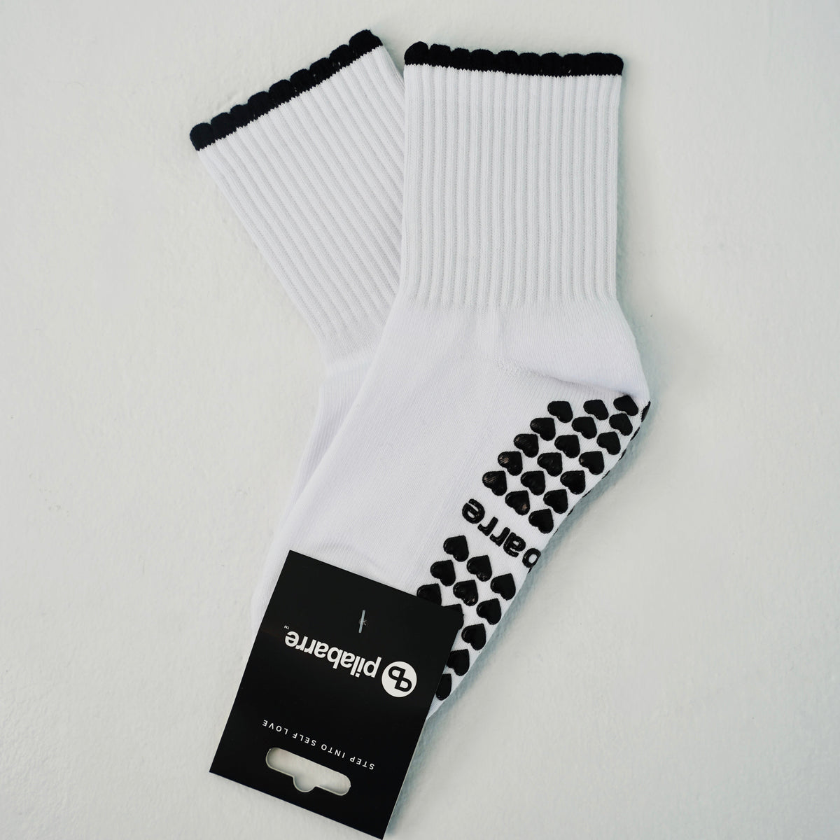 white and black barre socks and pilates socks with a ruffle 